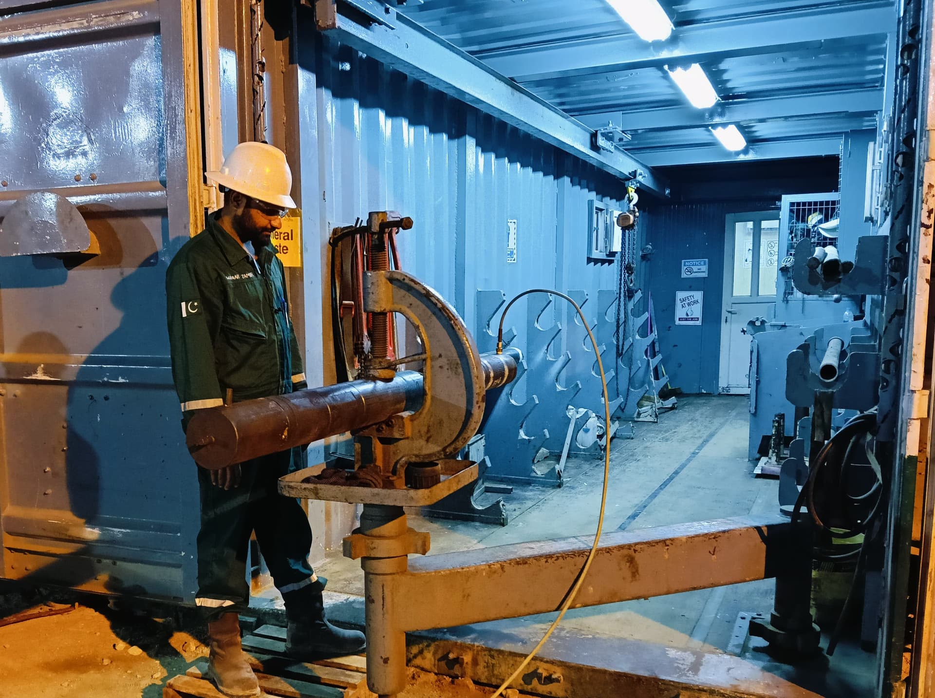 Technician making up drill stem testing tools in a mobile workshop