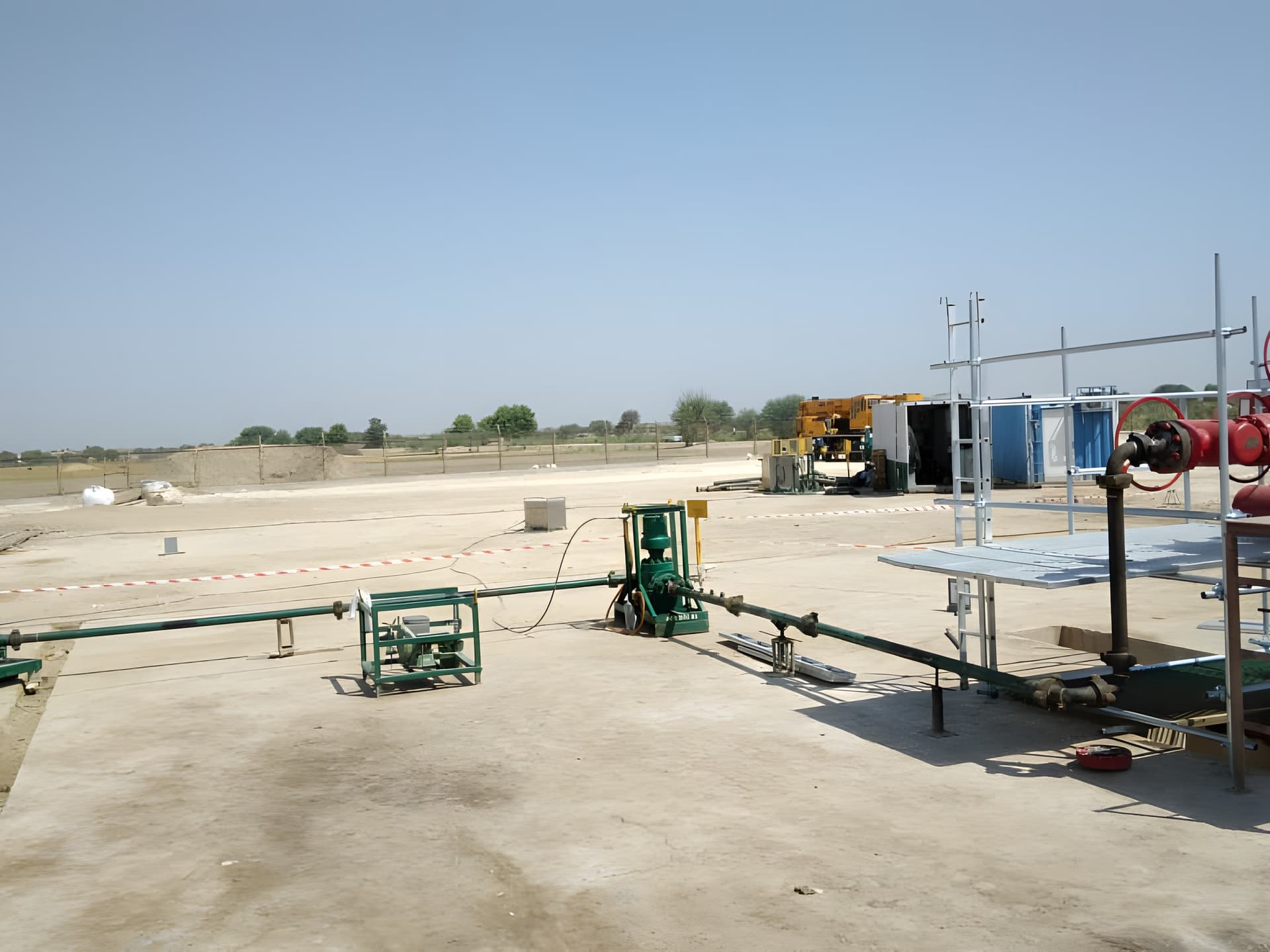 Green transfer pump and flowlines on a concrete wellsite pad