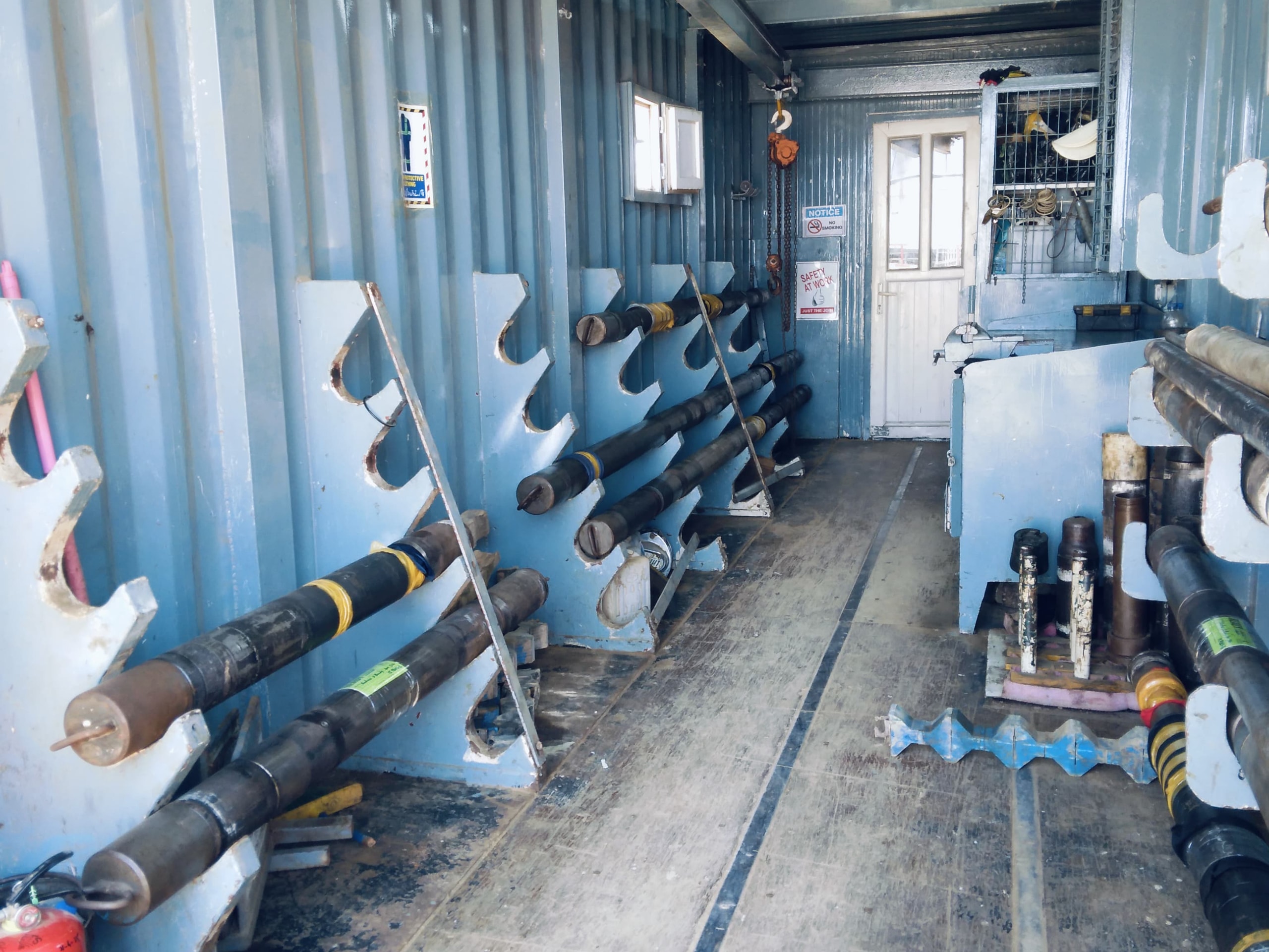 Mobile DST workshop container with racked downhole testing tools and equipment